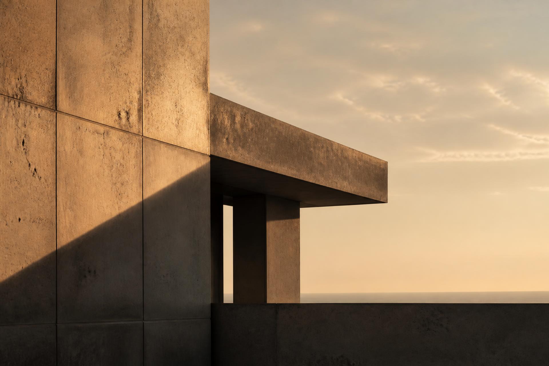Concrete architecture at dusk, meeting a distant horizon.